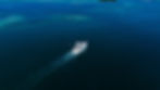 Fishing boat navigating in dark blue open seas drone shot mauritius