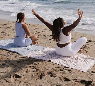 Black women meditating on beach.jpeg