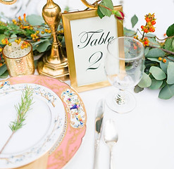 East Tennessee wedding  reception at Ijam's nature Center.  place settings with mismatched china and gold candelabra