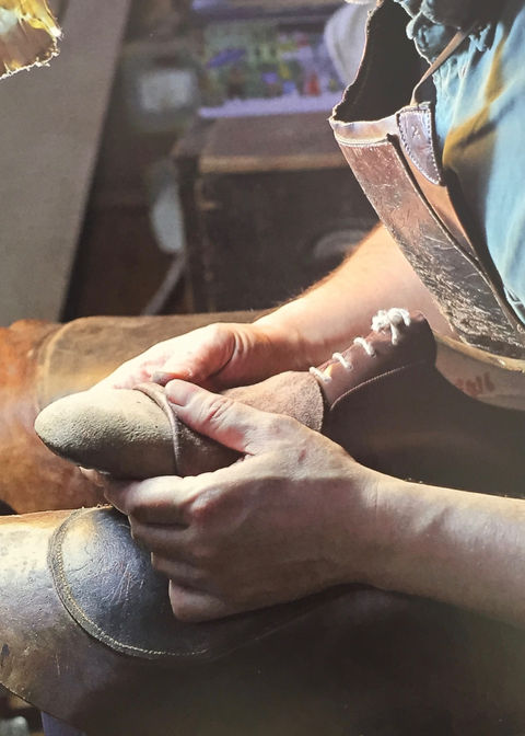 Mariano working on the toe of leather shoe.