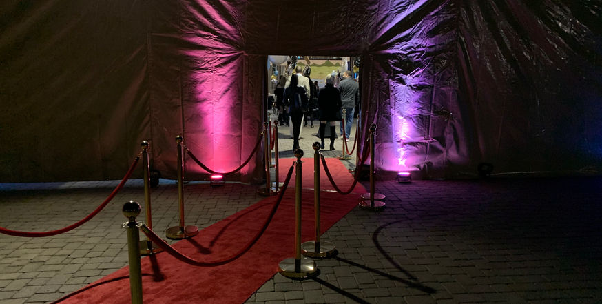 Red Carpet Entrance with stanchions and red velvet rope with LED Uplights