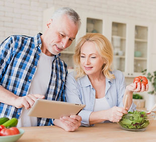 smiling-senior-couple-looking-digital-ta