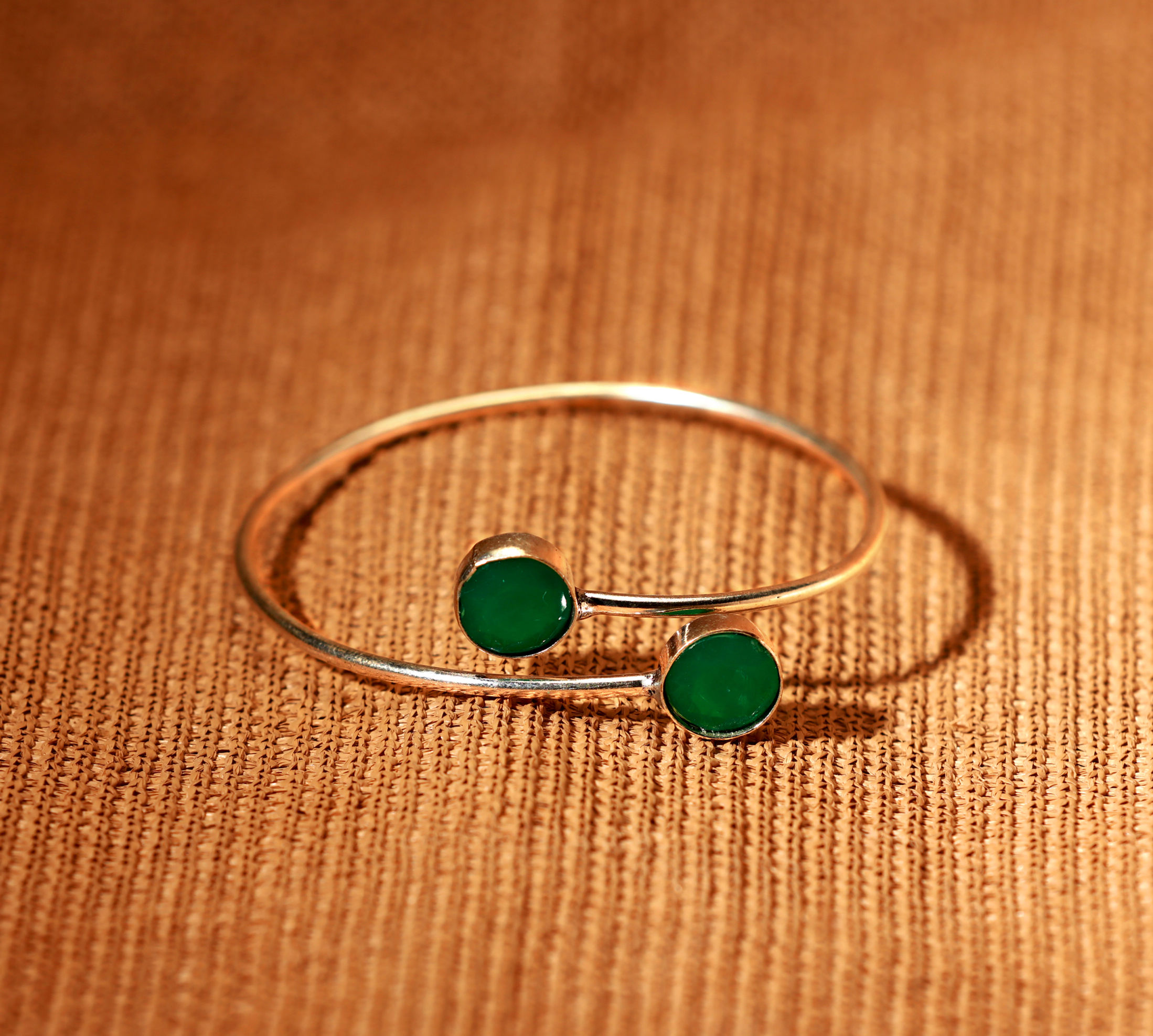 Golden bracelet with dark green stone