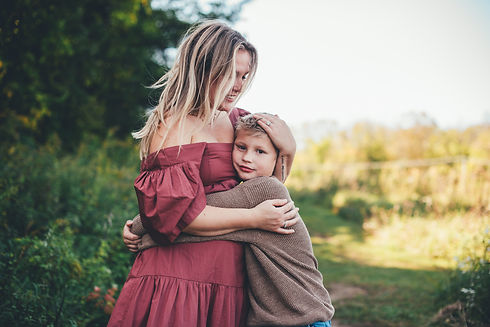 Mom hugging her son into her chest