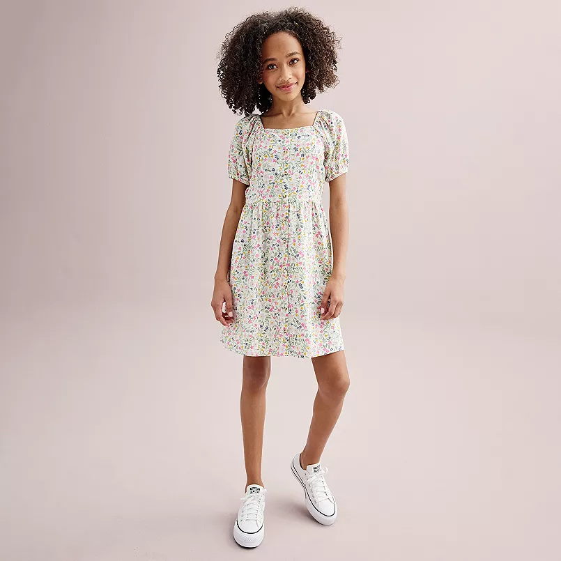 girl in floral dress and sneakers