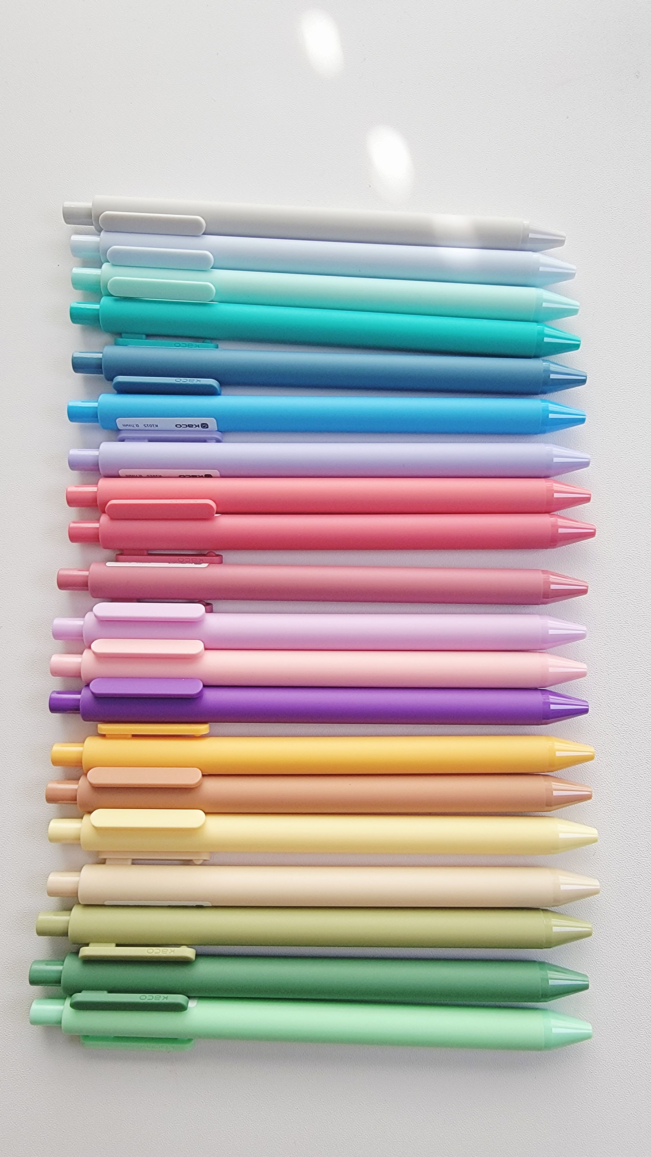 Flat lay of pastel gel pens arranged by color – Whimsy & Wonder Collective