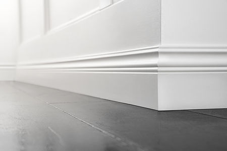 Close up of decorative, moulding white baseboard corner in empty room with copy space.jpg