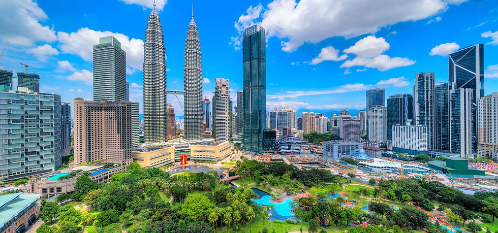 A sunny day in Kuala Lumpur. View of the city skyline with Petronas Towers and the KLCC Park perfect for families