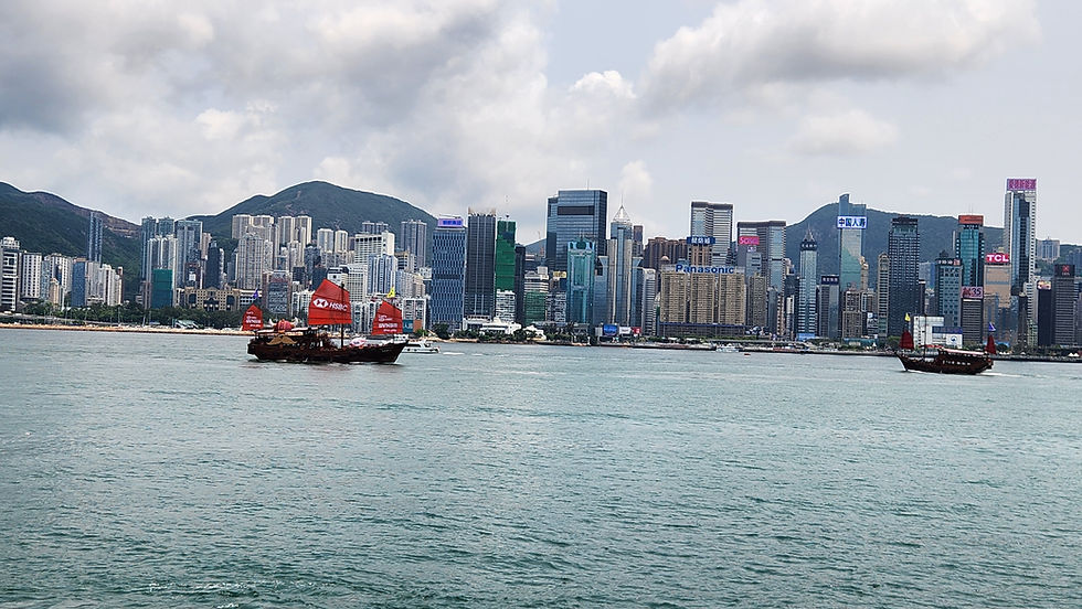 Hong Kong skyline with a traditional Junk boat sailing by