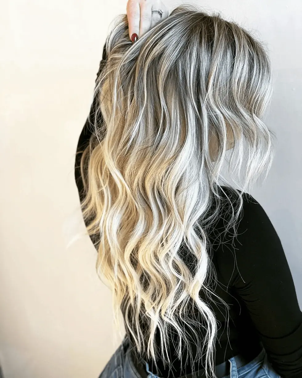 Long blonde hair extensions with dimensional color and waves