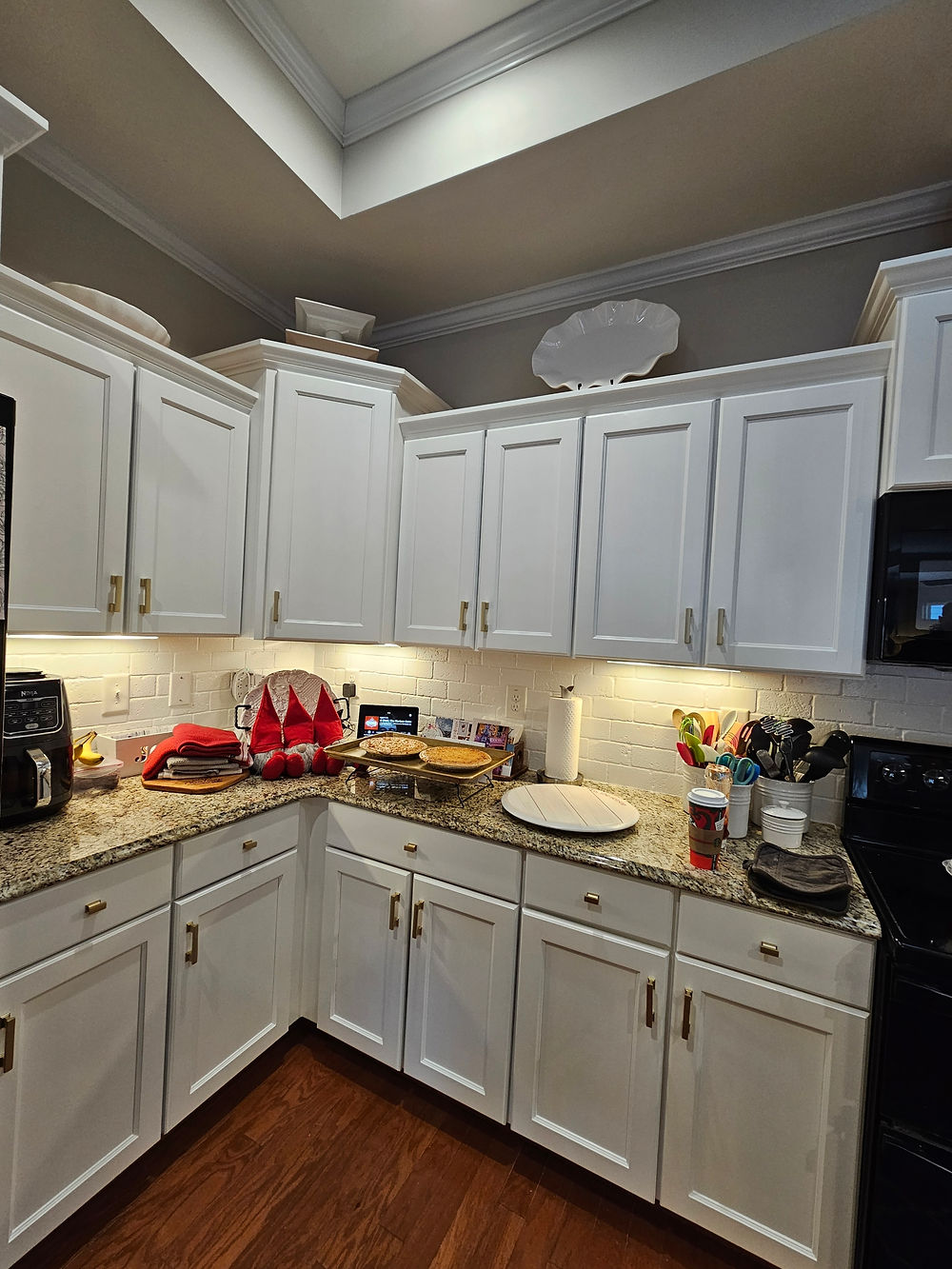 Modern kitchen with white cabinets, granite counters