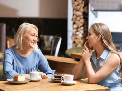 Mother and daughter sitting at a table having a conversation