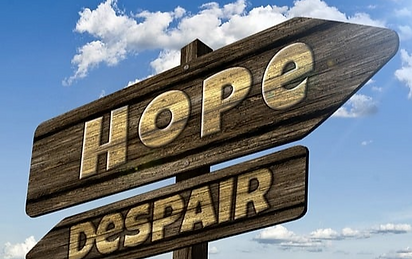 A sign post with Hope and Despair pointing in different directions