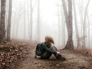 Woman sitting on a path in the forest
