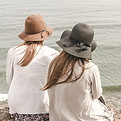 Two women sitting on the beach