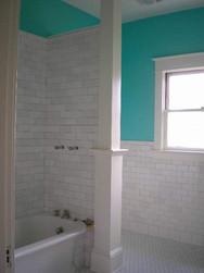 Here's the nearly completed shower with the blended white subway tile. We were able to keep the original tub, but it was a challenge.