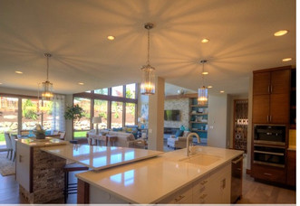 Light and bright quartz countertops mix with rustic stone and sleek cabinetry