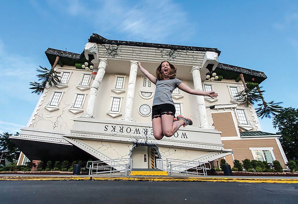 A fun and lively image of a young girl jumping with excitement in front of the WonderWorks building, designed to look as if it is upside-down.