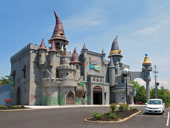 Castle of Chaos Attraction: A whimsical, fantasy-themed castle with exaggerated towers and stone walls, representing the Castle of Chaos attraction.