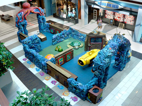 Ocean-Themed Adventure Play Area: A detailed ocean-themed play space with large coral formations, an octopus archway, and interactive elements, designed to immerse children in a fun and educational underwater world.