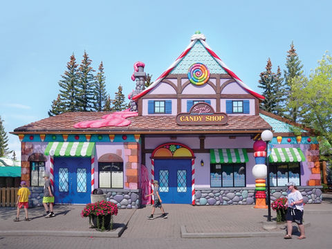 Sweet Tooth Candy Shop: A colorful, whimsical candy shop with playful oversized candies decorating the exterior, perfect for attracting families and kids.