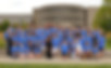 A large group standing together. Everyone is wearing blue shirts.
