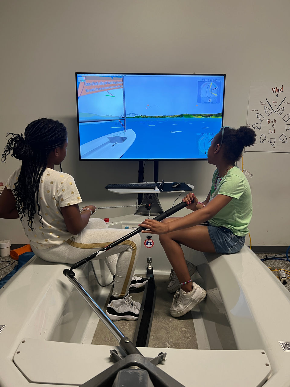 Two girls using a sailing simulator