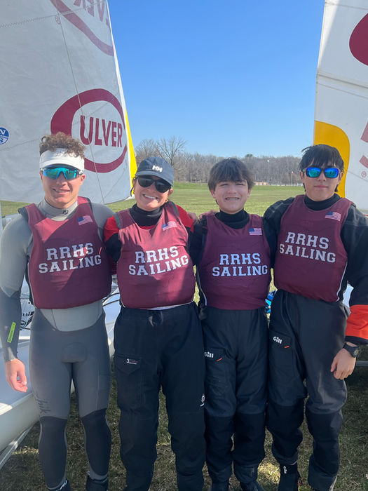 Four Army Sailing team members with sailboats