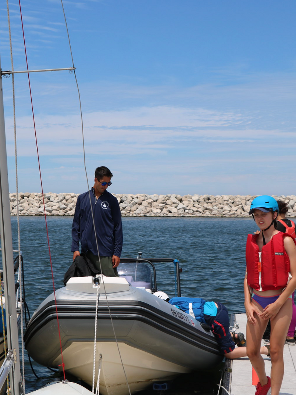 Children and instructors on a boat at sailing camp