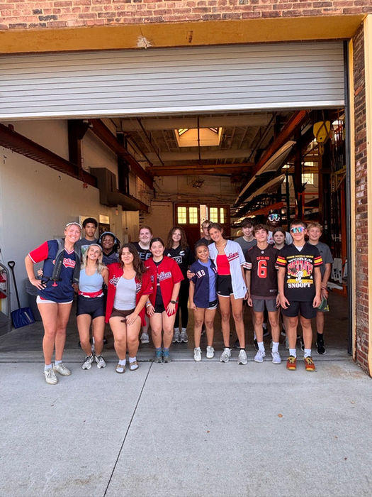 CFJ High School athletic team at boathouse