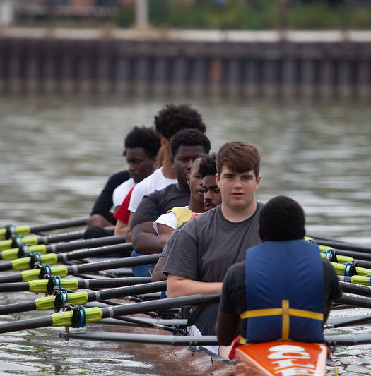 Crew team rowing on the water