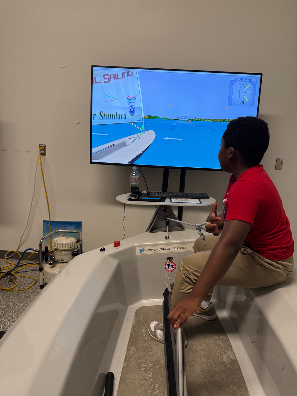 Boy operating a sailing simulator