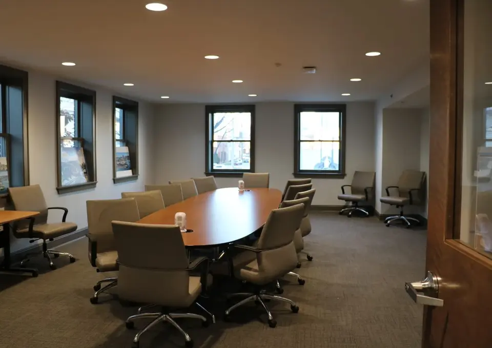 Empty conference room with oval table and chairs