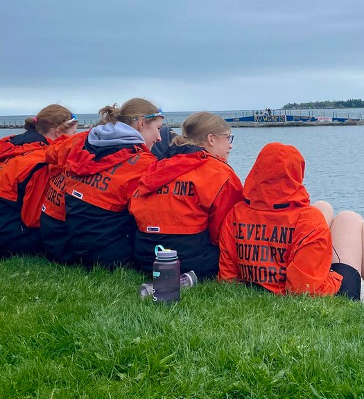 CFJ students in orange jackets by water