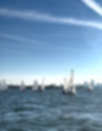 Sailboats on blue water under a clear sky