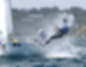 Sailboat with two people splashing through water