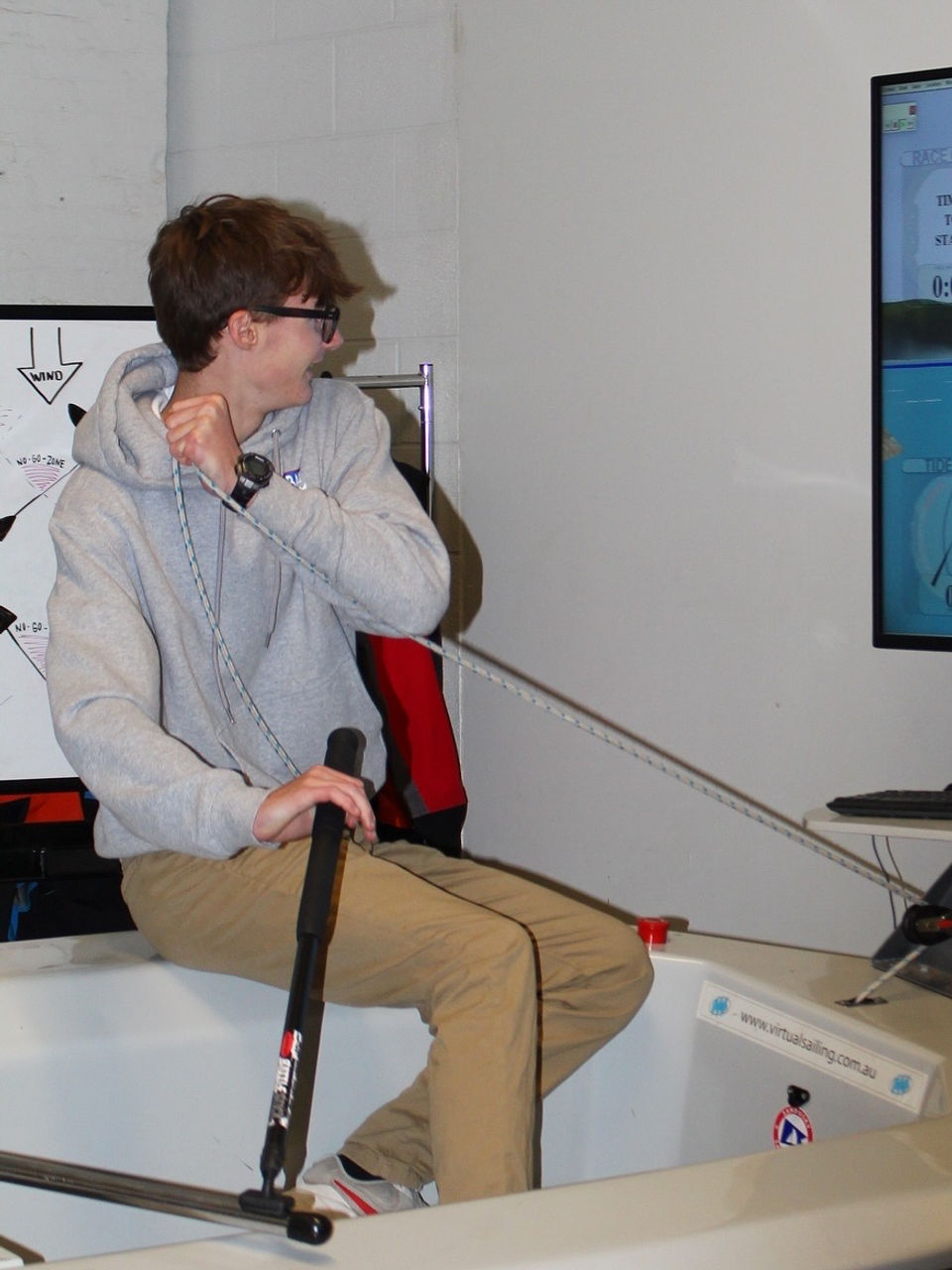 Young man operating a sailing simulator