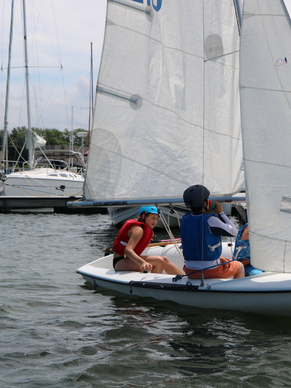 Two sailors in a small boat with sail number 8