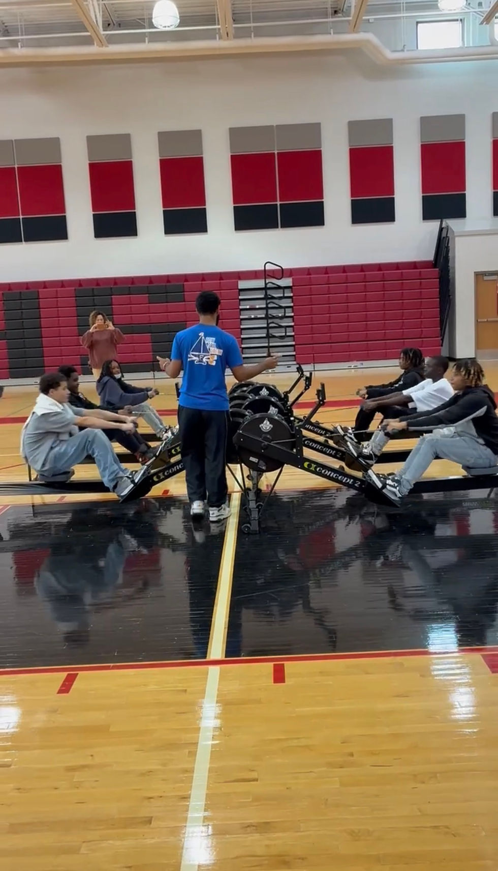 Rowers training on ergometer machines in a gym