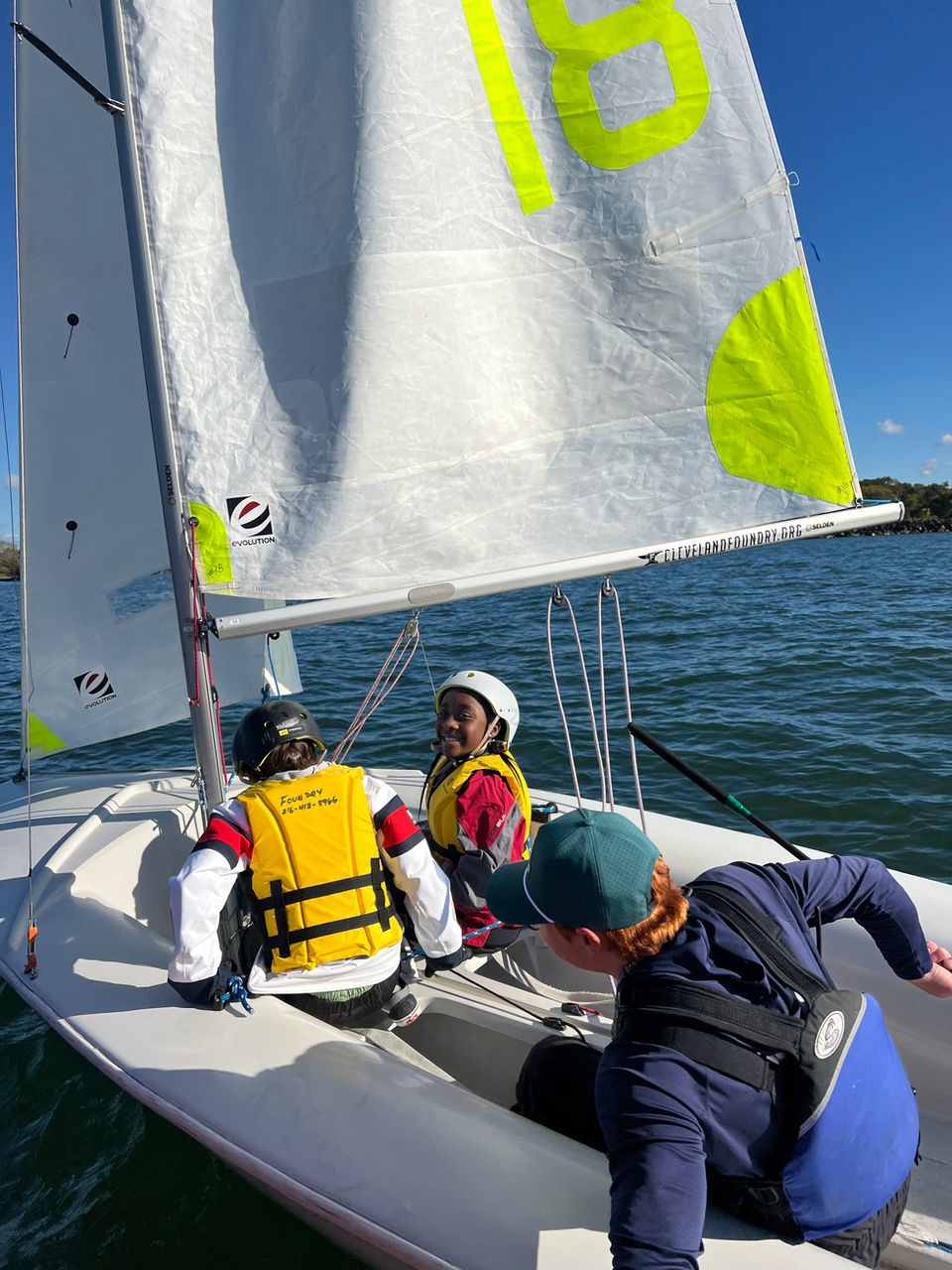 Three children sailing a boat