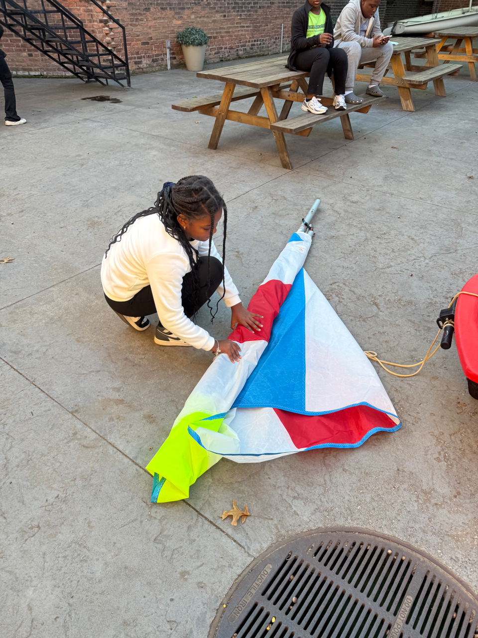 Person assembling a colorful sail