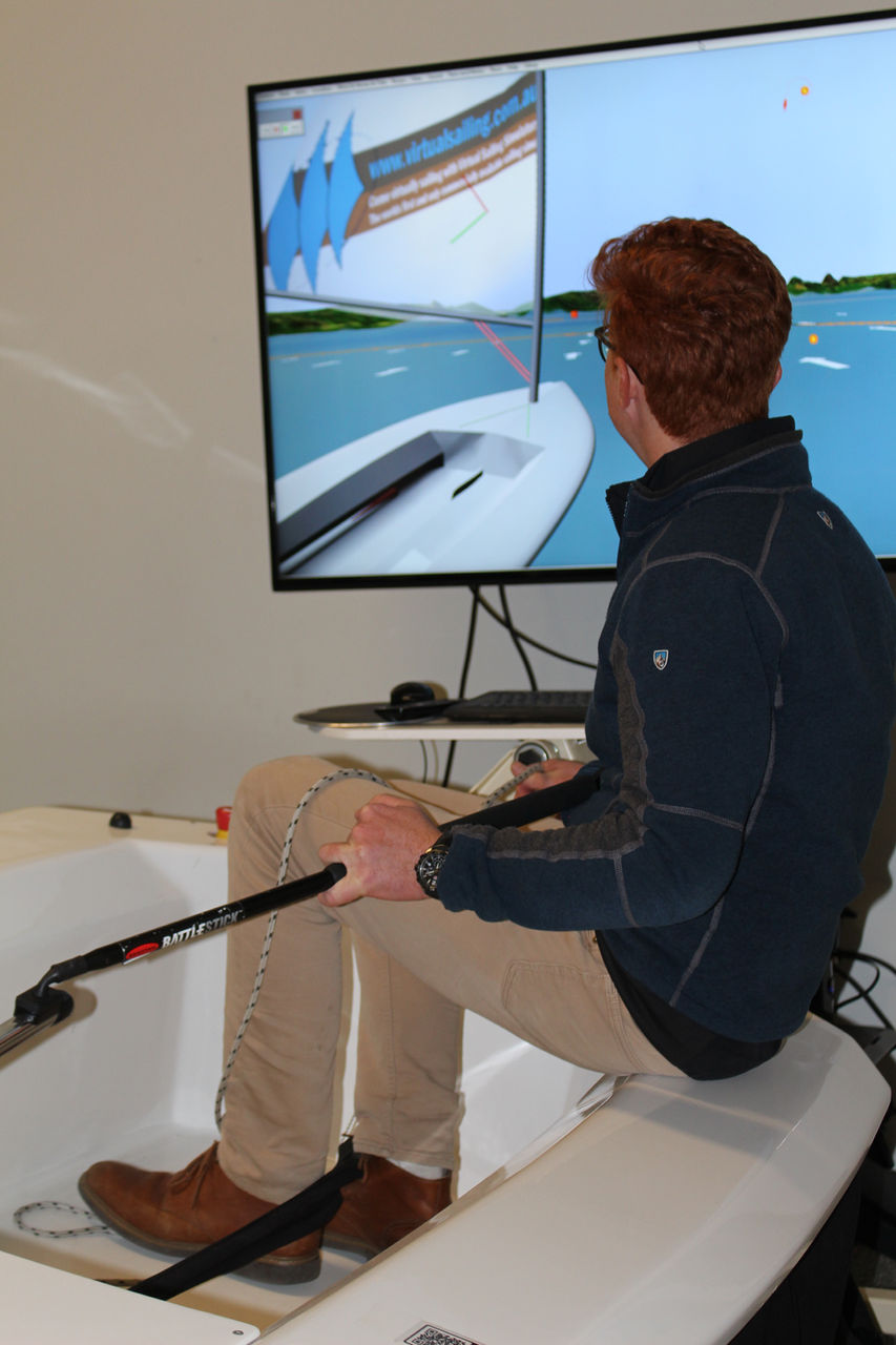 Person operating a sailing simulator