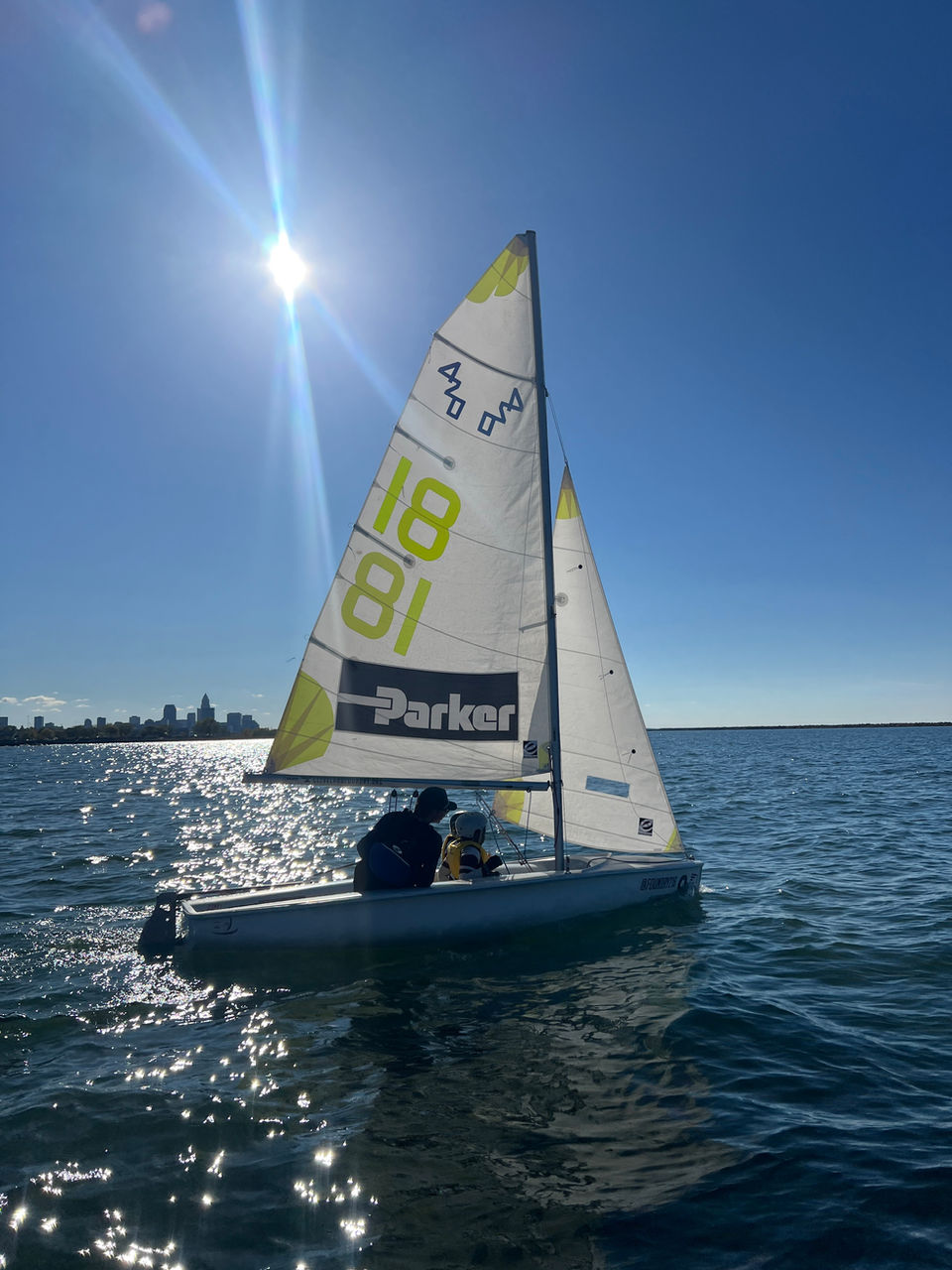 Sailboat sailing on water under bright sun