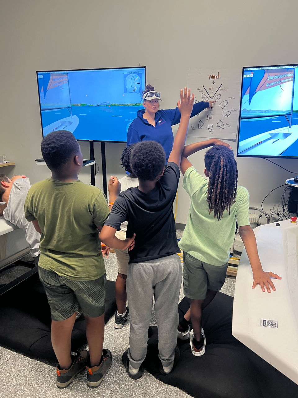 Instructor teaching children with sailing simulators