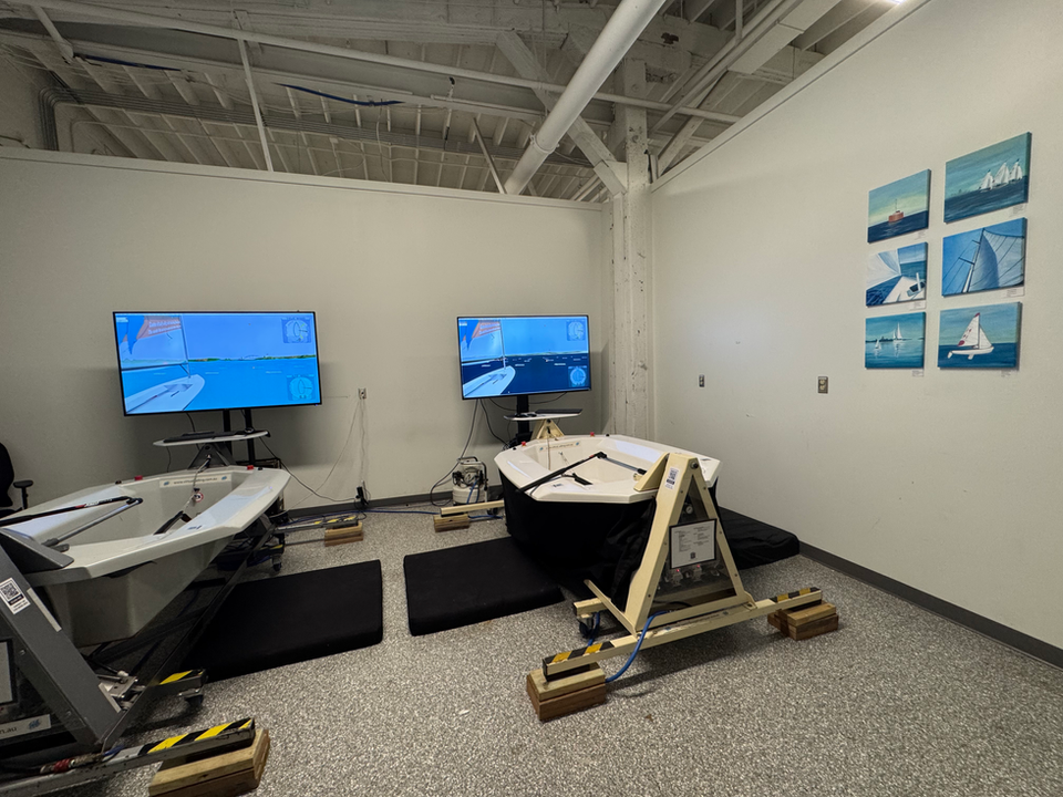 Two sailing simulator stations with screens showing sailing scenes