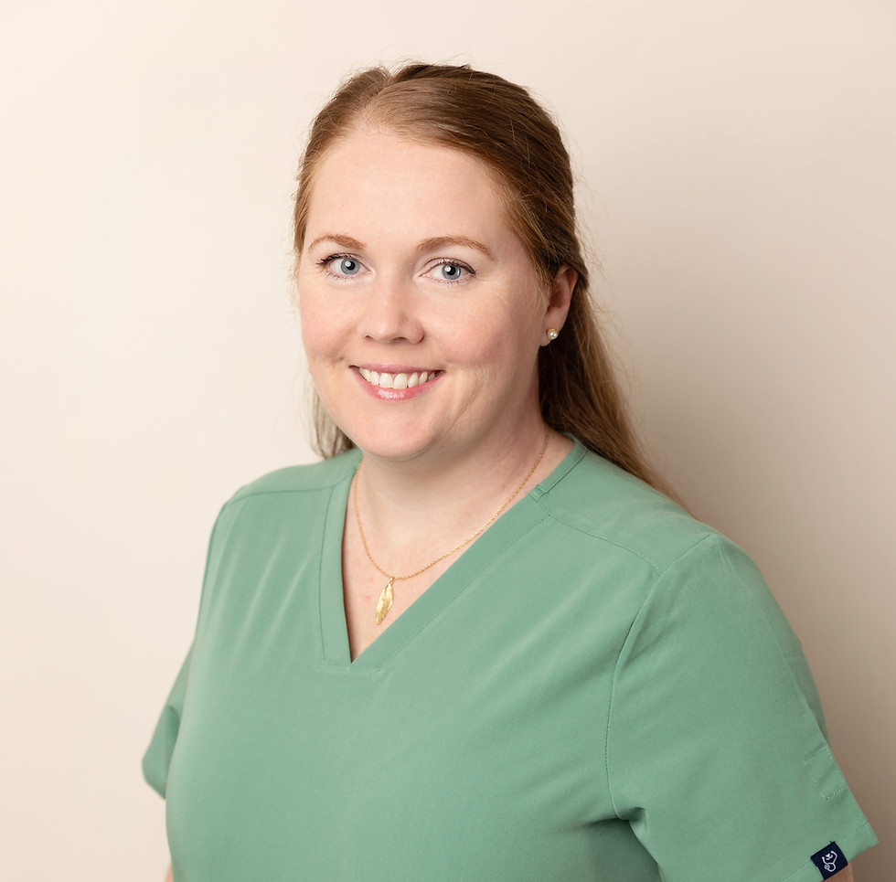 Professional woman smiling in green scrub top