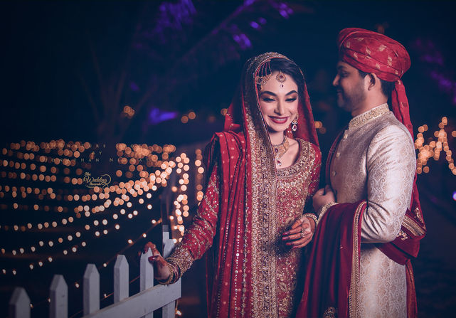 Lovely Pakistani couple wearing amazing attire on their wedding in London, being happy, clicked by the wedding records.