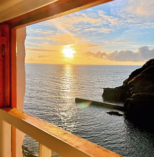 Sunrise over the sea from the bedroom window of Cliff Villa, Portloe