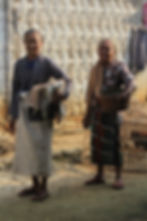 Craftswomen carrying finished Lana Daya fabrics