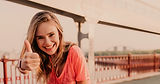 fascinating-female-runner-posing-with-thumb-up-portrait-lovable-caucasian-girl-enjoying-mo